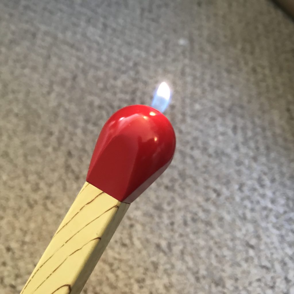 Tip of a large butane match stick lighter, ignighted