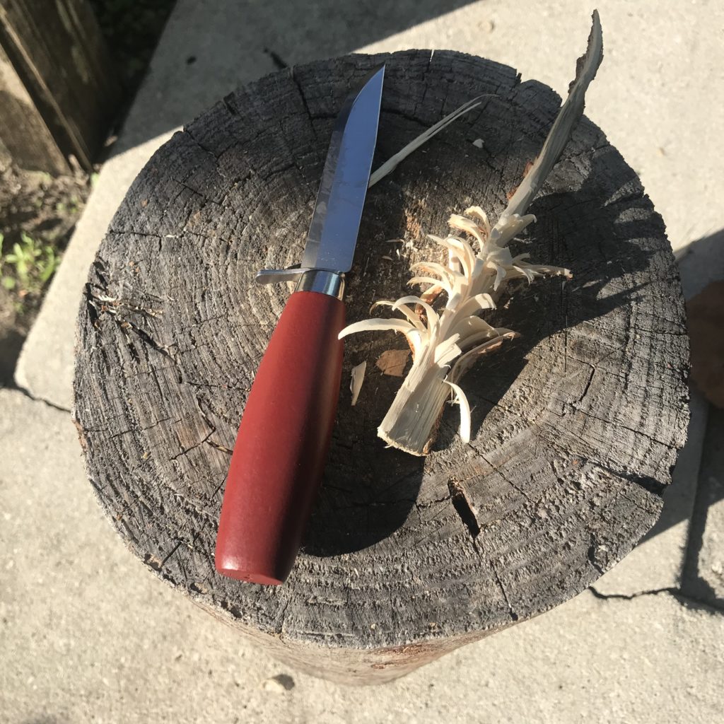 Another feather stick and knife on a stump
